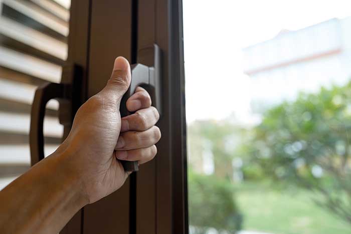 Hand holding a window lever