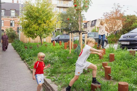 Children playing outside some houses