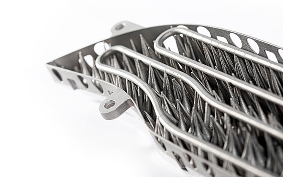 Underside of a 3D-printed metal lamination tool with cooling channels for automotive use