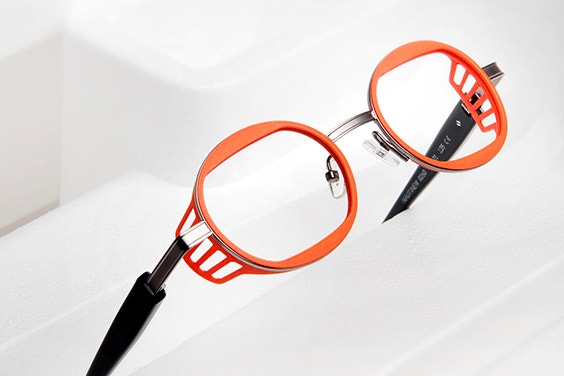 Orange eyeglasses from the ReyStudio NAUTINEW collection, unfolded and tilted upward