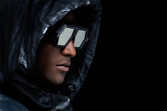 Black male model wearing a hood and looking to the side while wearing VAVA Red Label eyewear