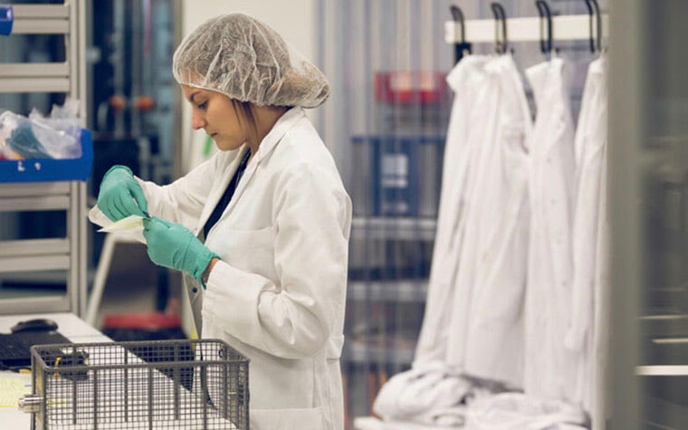 Woman in a lab coat working in a lab