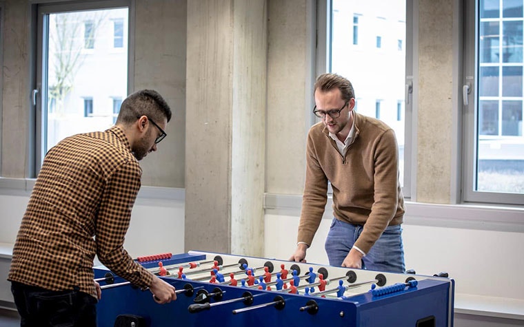 Men playing foosball at Materialise