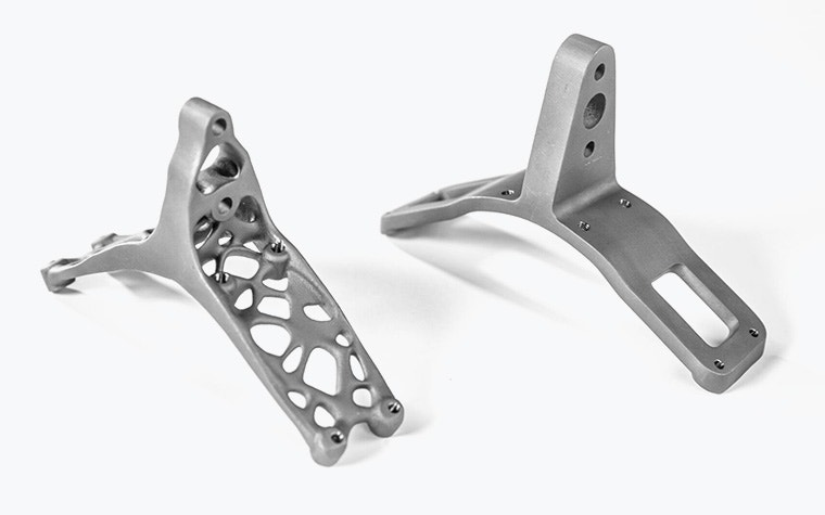 Side-by-side comparison of 3D-printed titanium lift brackets. One is solid and the other has an optimized lightweight design with holes