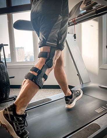 Man running on treadmill wearing a custom 3D-printed brace by Berretta Medical Inc.