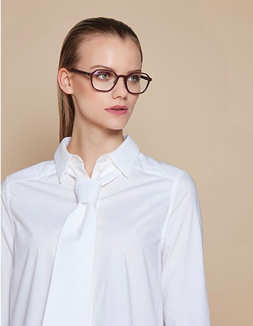 Female model looking off camera, wearing black glasses from the BAARS Selasi collection