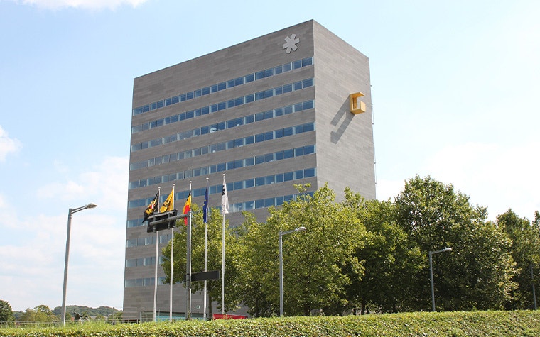 The Leuven Provinciehuis with flags and trees in front