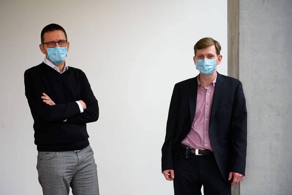 Two UZ Leuven staff members posing with face masks on