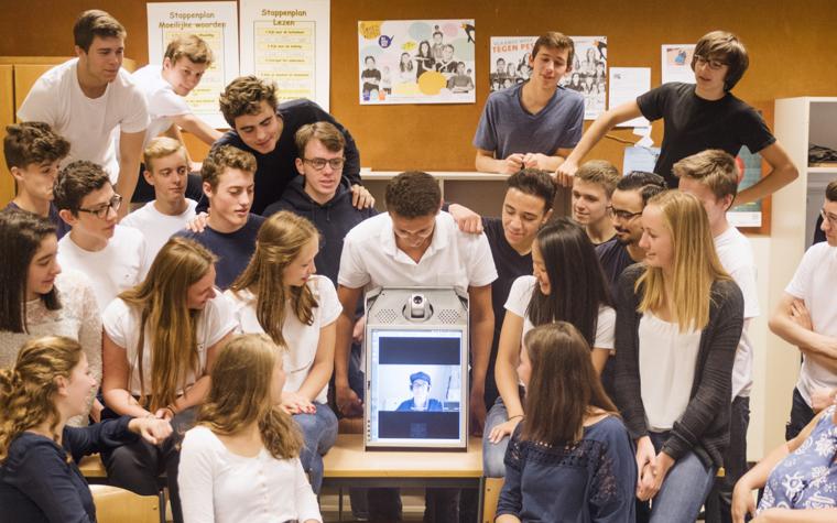 Group of kids looking at a person on a screen