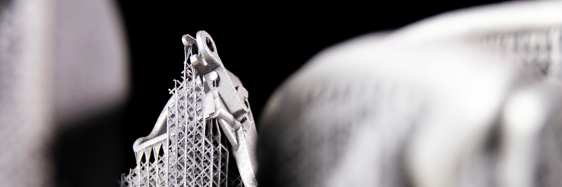 Close up of the 3D-printed metal component with support structures