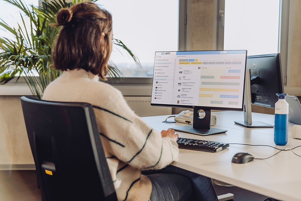 Mujer sentada en un escritorio usando el software Materialise