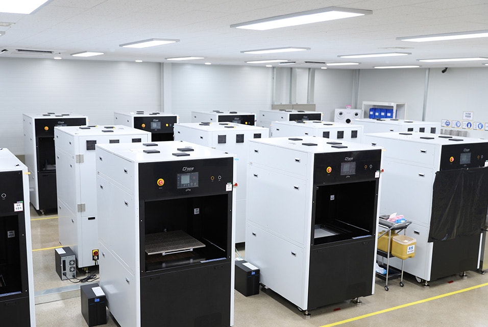 A factory with rows of 3D printers.