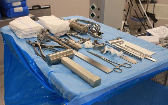 Surgical tools and personalized surgical guides on a table, ready for surgery