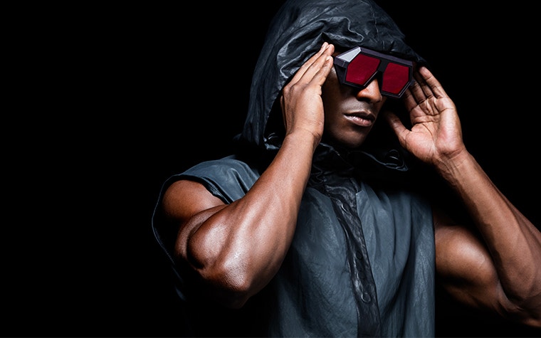 Black male model holding Vava Red Label sunglasses on his face
