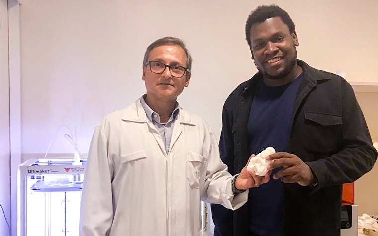 Dr. Werner holding a 3D-printed model with Gerson Ribeiro, the Digital Media Developer