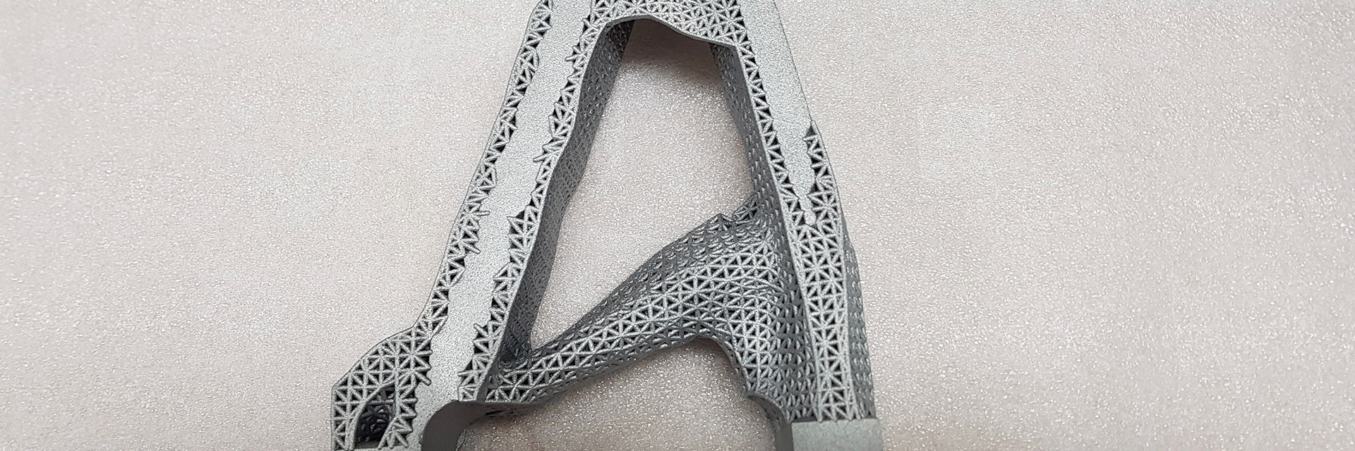 Triangular metal 3D-printed aerospace part with lattice structure 