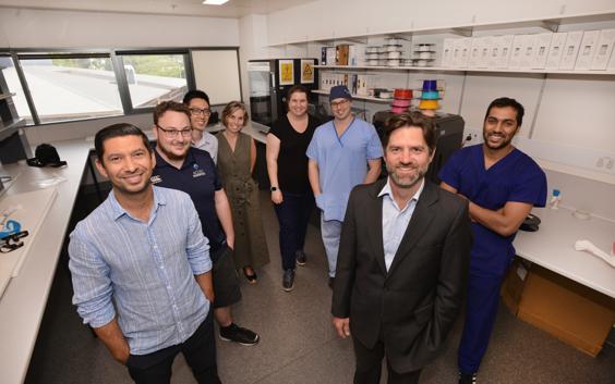 Group photo of the ACCISS team members in a 3D printing lab