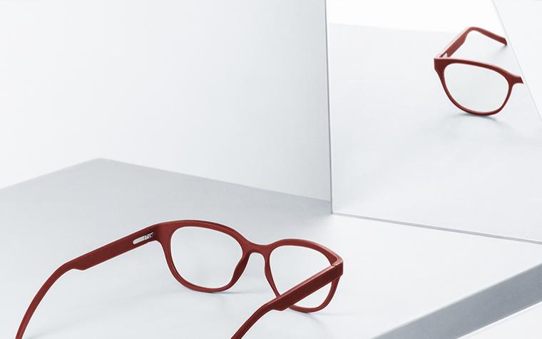 Red Yuniku+Orgreen eyeglasses reflected in a mirror
