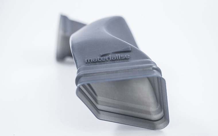 Close-up of part 3D printed using Taurus, with Materialise name and logo  