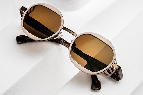 Close-up of sunglasses from the ReyStudio NAUTINEW collection, folded up on a white surface
