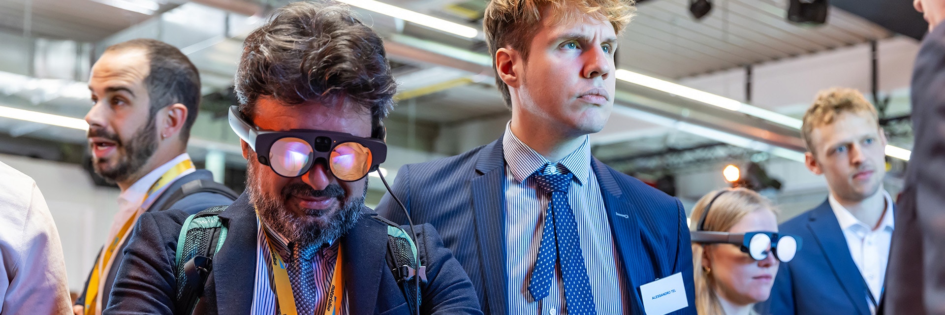 People at a conference wearing AR glasses and testing out new functionalities of Materialise software.