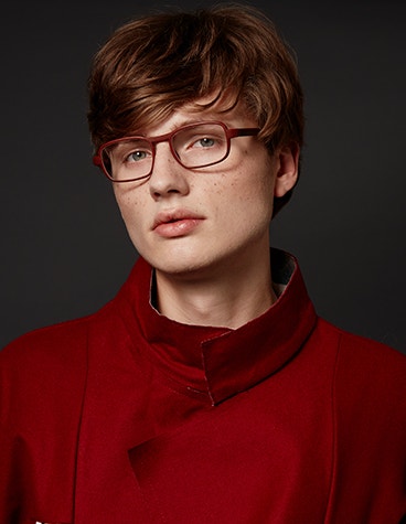 Male model wearing a red shirt and red Hoet Cabrio PZ eyeglasses