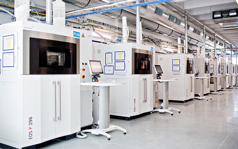 A row of EOS 3D printers in Materialise's 3D printing facilities