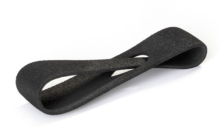A black 3D-printed loop made from Ultrasint TPU 90A-01 using Multi Jet Fusion, with a normal finish.