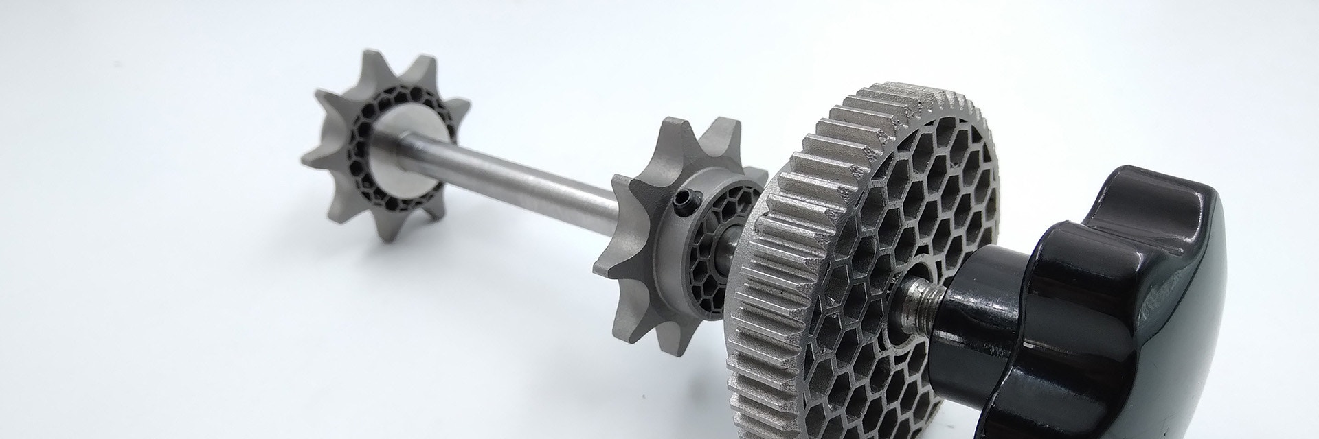 A metal shaft with 3D-printed gears and sprockets