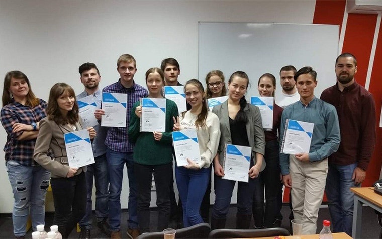A classroom of students at Materialise Ukraine. They are holding certificates.