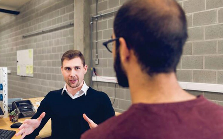 Two men speaking in an office