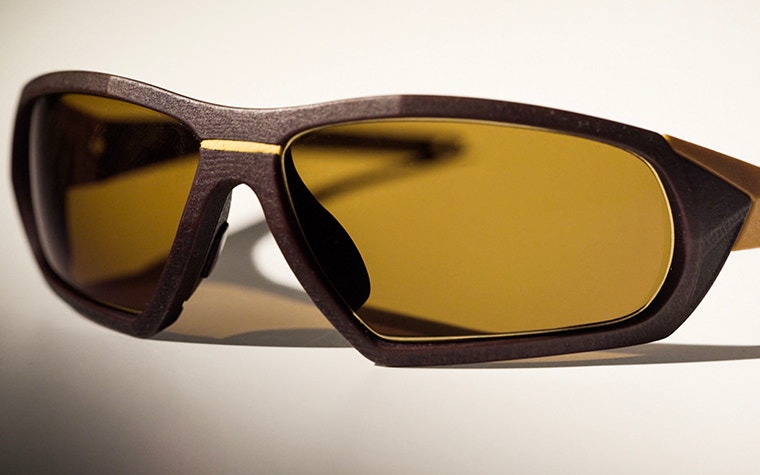 Pair of SEIKO Xchanger glasses with brown frame, yellow accents, and smoke-tinted lenses, seen from front 