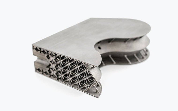 Satellite insert 3D-printed in titanium, cut to show interior lattice structure 