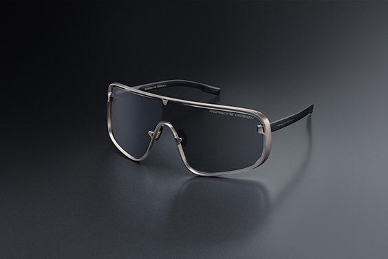 Angled view of Porsche sunglasses sitting on a dark surface