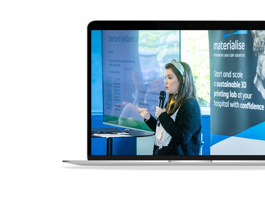 An image of María Gloria Álvarez Caballero speaking at the 3D Printing in Hospitals Forum 2024 shown on a laptop screen