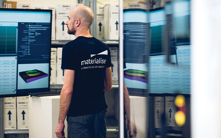 Man looking at a screen in a 3D printing production area