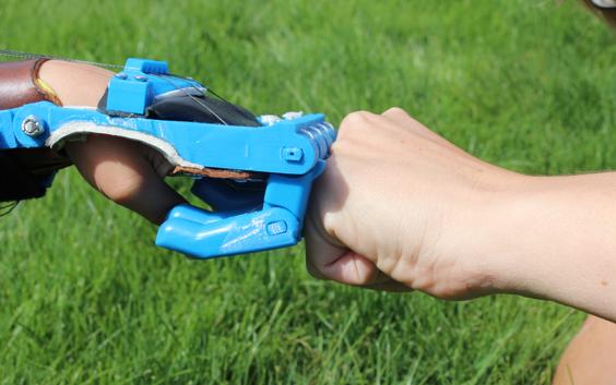 A 3D mechanical hand fist bumping another hand (wide image)