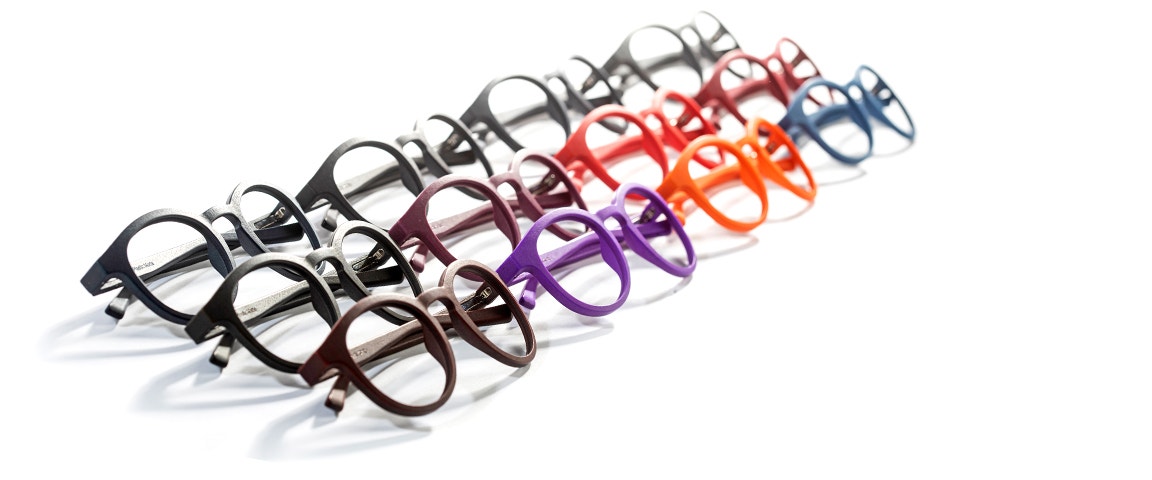 Rows of 3D-printed eyewear frames in various colors