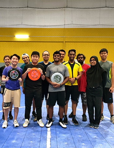 Materialise Malaysia team smiling and posing with frisbees