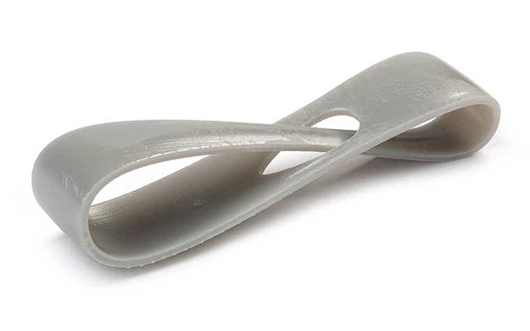 A gray 3D-printed loop made with Xtreme using stereolithography, finished by removing all support marks.