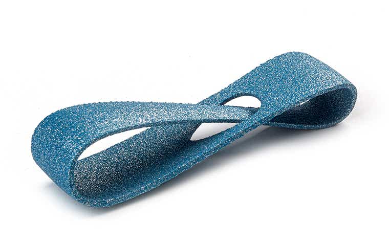A glittering petrol-blue 3D-printed loop made from PA-AF (aluminum filled) using laser sintering, with a color-dyed finish.