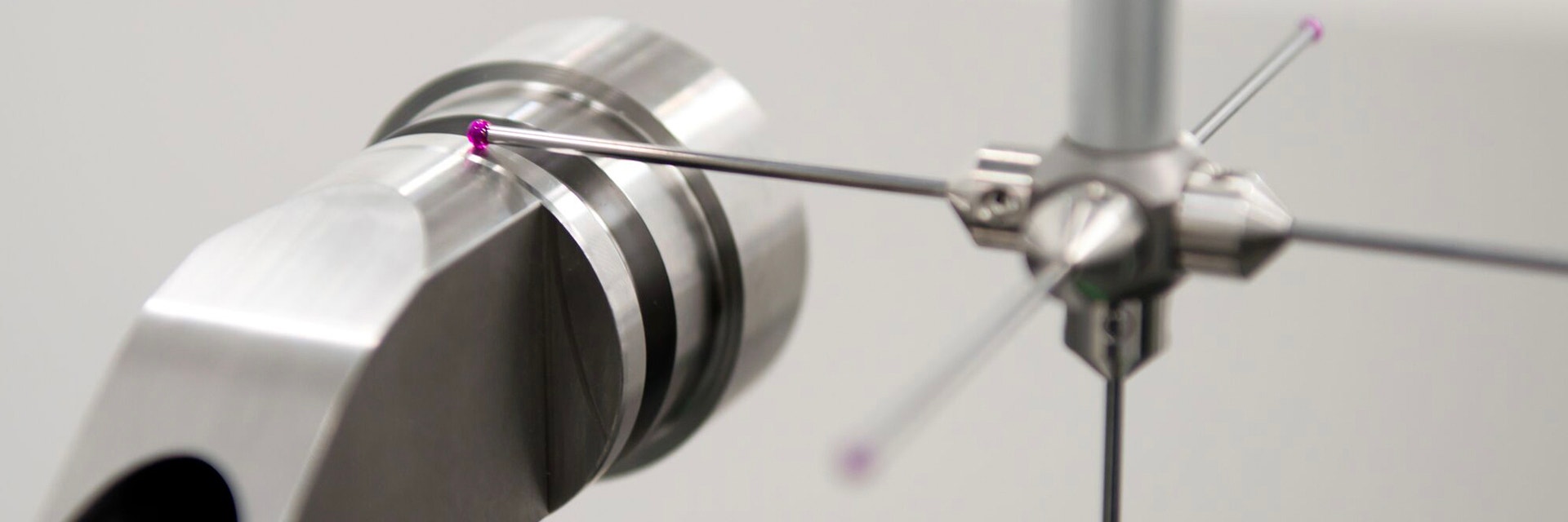 Close up view of a CMM Machine probe precisely measuring a milled part. 