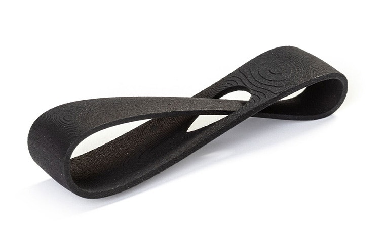 A black 3D-printed loop made in PA 12S using Multi Jet Fusion with a color dyed finish.