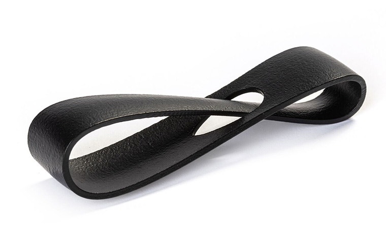 A black 3D-printed loop made from PA 12S using Multi Jet Fusion, with an extra smooth and color-dyed finish.