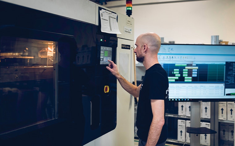 A man operating a 3D printer