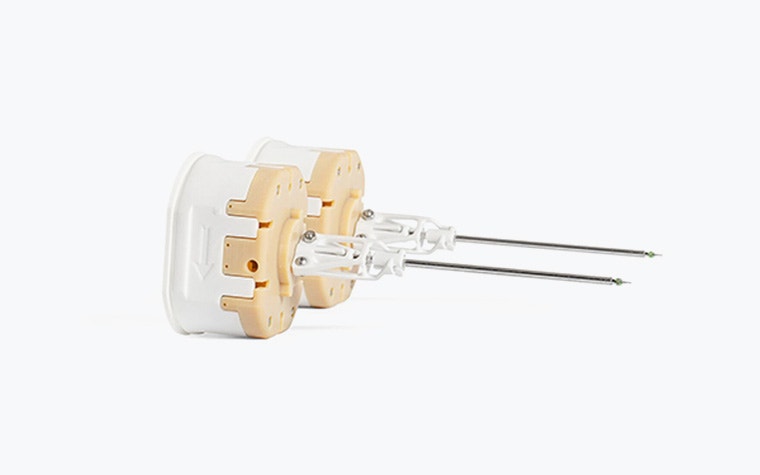 Two 3D-printed needle holders for medical instruments.