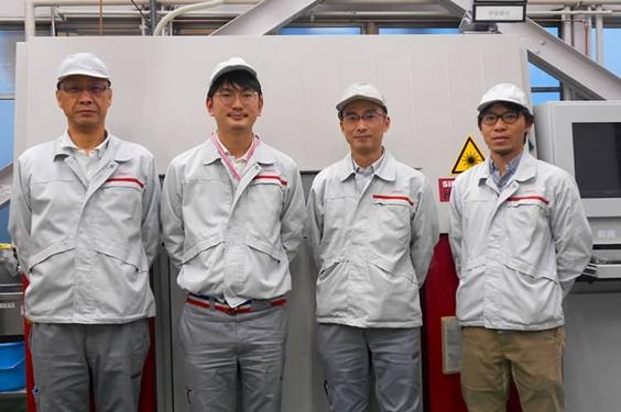 Nissan team standing in front of a 3D printer