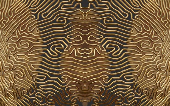 An abstract, symmetrical pattern rendered in metallic gold, resembling a labyrinth. The pattern is created through procedural modeling techniques for design and engineering. 
