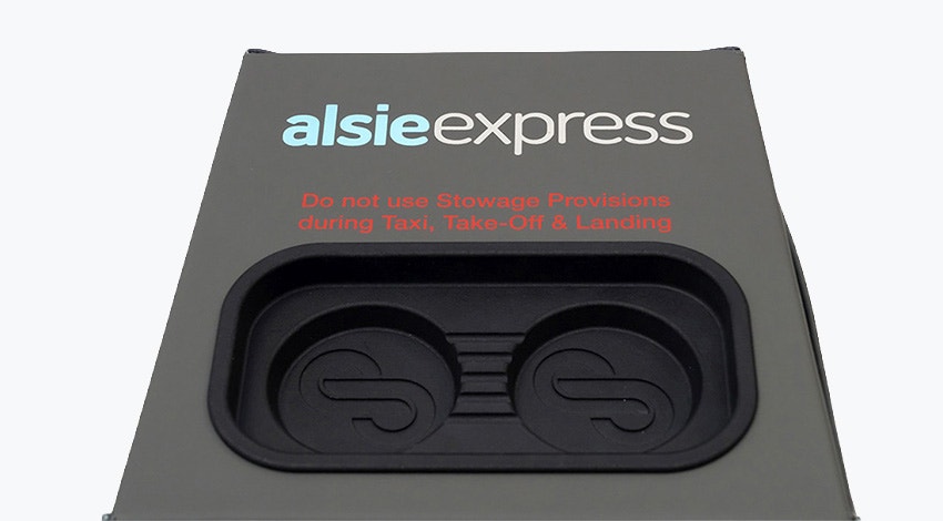 Stirling Dynamic's cube-like seat blocker, featuring handcrafted grey/green leather and a black 3D-printed insert in the top side for smartphones and other devices.