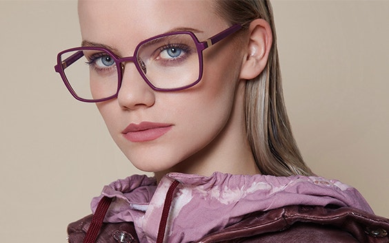 Female model looking into the camera, wearing a purple top and purple frames from BAARS SELASI eyewear